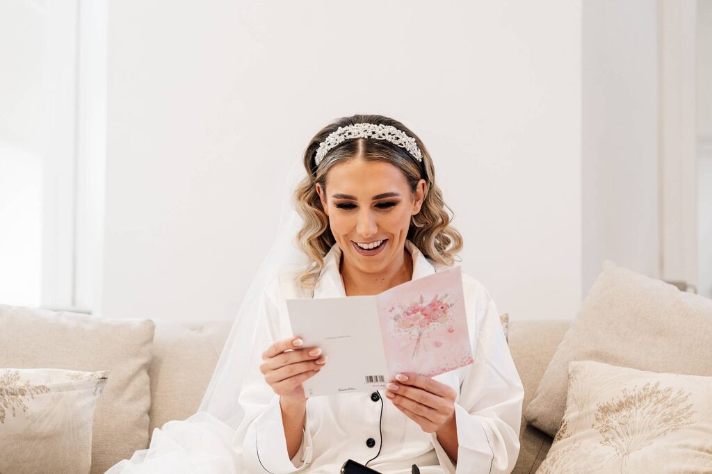 Bride reading a card from groom during bridal prep